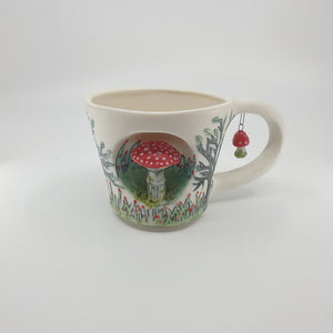 Porcelain cup with red mushroom and trees