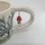 Porcelain cup with red mushroom and trees