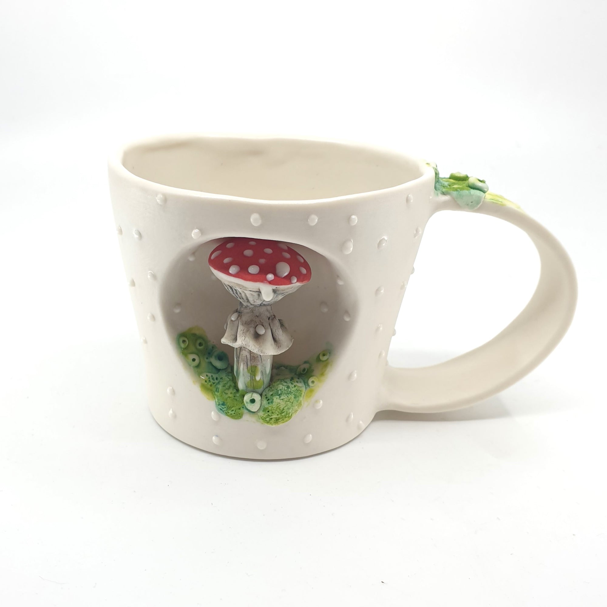 Porcelain cup with red mushroom