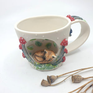 Porcelain fox cup with red mushrooms and leaves