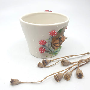 Porcelain fox cup with red mushrooms and leaves