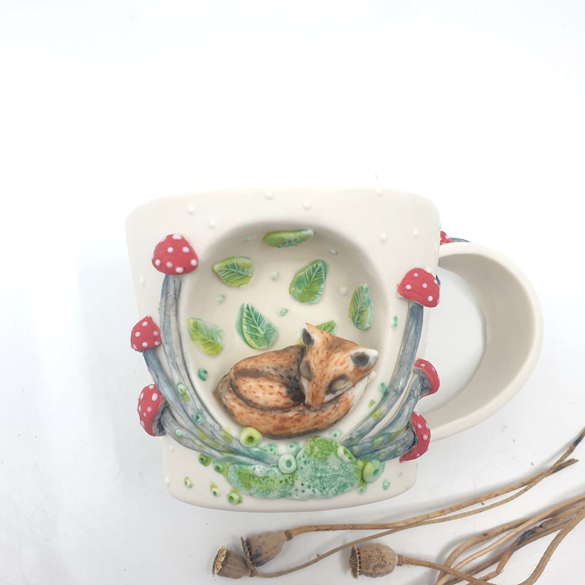 Porcelain fox cup with red mushrooms and leaves