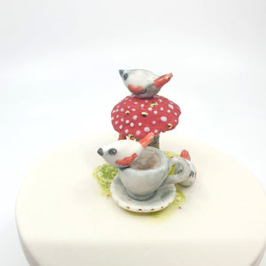 Porcelain sugar bowl with mushroom, tea cup and birds