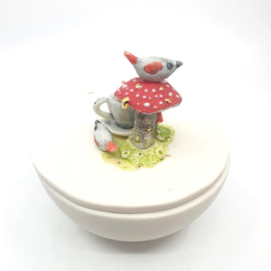 Porcelain sugar bowl with mushroom, tea cup and birds