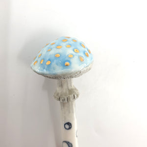 Porcelain ceramic spoon with blue mushroom
