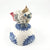 Baby Bird with red wings and tail on blue floral stand