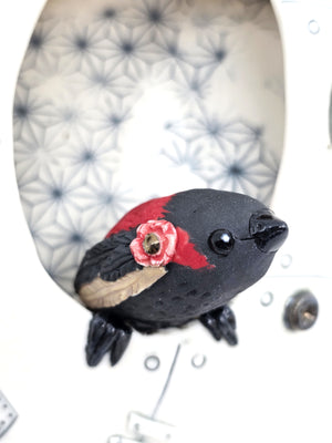 The hearts messenger (red and black finch)